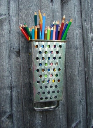 Attach a cheese grater to the wall to hold pens & pencils.